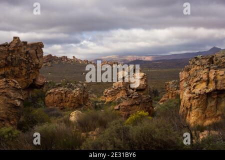 A valley in the Cederberg Mountains of South Africa, Strewn with weathered sandstone boulders, on an overcast day Stock Photo