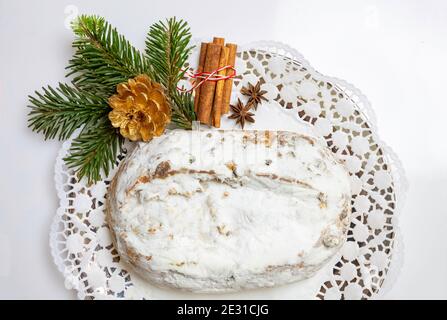 Christstollen Christmas stollen cake and decoration on white. Sweet german traditional bread with raisins, nuts, spices, dried fruits and icing sugar, Stock Photo