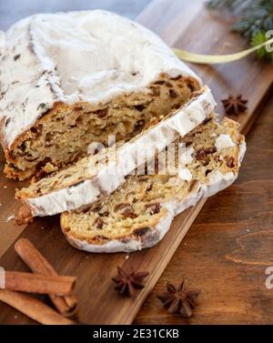 Christmas stollen cake sweet german traditional bread, Christstollen slices on wooden background. Seasonal dessert closeup view Stock Photo