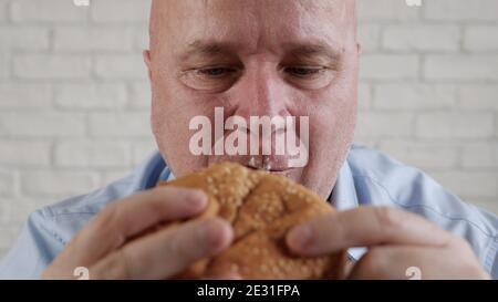 Hungry Person Eating a Tasty Hamburger, Enjoy Delicious Fast Food Stock Photo