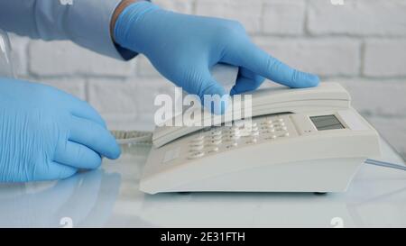 Image with Businessman Hands Wearing Protective Gloves Using Telephone Stock Photo