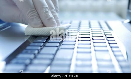 Closeup Image with Hands Wearing Protective Gloves Using the Laptop Keypad Stock Photo