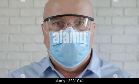Engineer Portrait Wearing Protective Eyeglasses, and Medical Face Mask in Coronavirus Pandemic Stock Photo