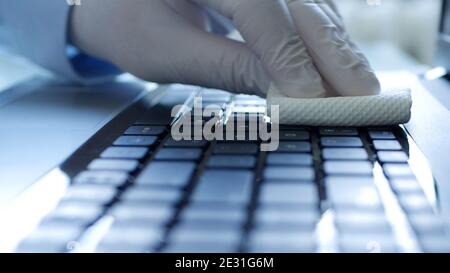 Closeup Image with Hands Wearing Protective Gloves Using the Laptop Keypad Stock Photo