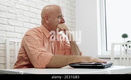 Image with an Upset and Disappointed Businessman Using a Laptop Stock Photo