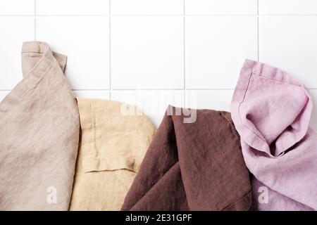 Four multi-colored napkins on cooking stone table with kitchen towel or napkin. Top view with space for your meal or recipe. Stock Photo