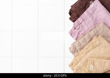 Four multi-colored napkins on cooking stone table with kitchen towel or napkin. Top view with space for your meal or recipe. Stock Photo