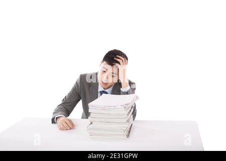 Portrait of young man sitting on desk with stack of files,portrait high quality photo Stock Photo