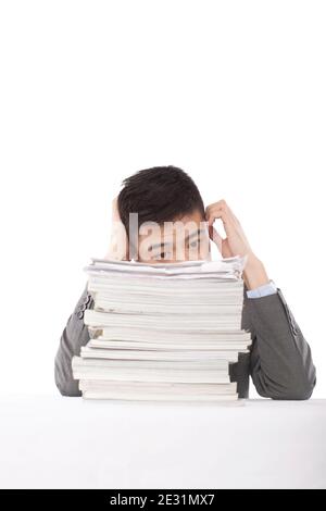 Portrait of young man sitting on desk with stack of files,portrait high quality photo Stock Photo
