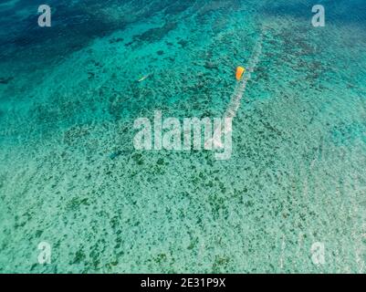 Kitesurfer and windsurfer in tropical blue ocean at Mauritius. Aerial view. Stock Photo