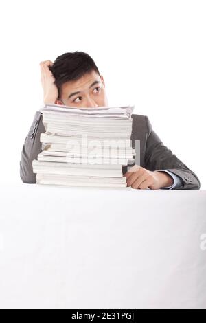 Portrait of young man sitting on desk with stack of files,portrait high quality photo Stock Photo