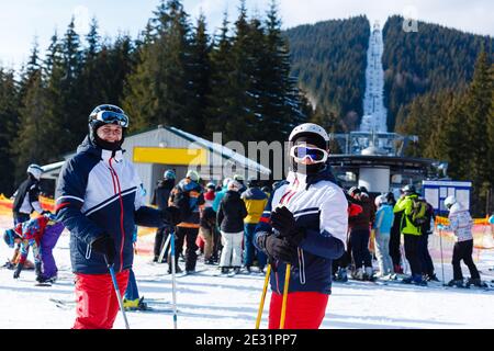 Portrait of smiling couple on skis in the mountains Stock Photo