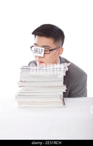 Portrait of young bisinessman leaning on stack of files high quality photo Stock Photo