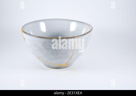 Gray Kintsugi bowl, real gold restoration, japanese technique Stock Photo