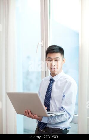 Portrait of young bisiness man with laptop high quality photo Stock Photo