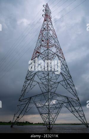 National grid electricity pylons on the meghna river at Ashuganj, Brahmanbaria, Bangladesh. Stock Photo