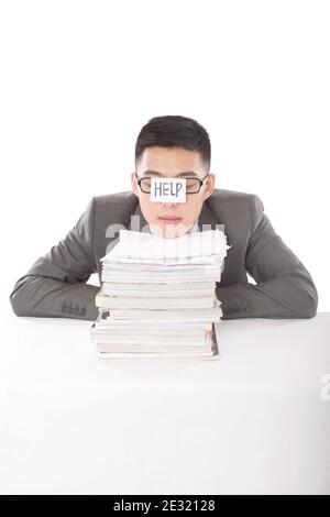Portrait of young bisinessman leaning on stack of files high quality photo Stock Photo