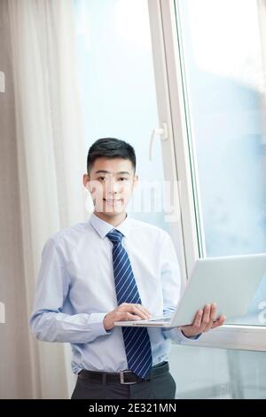 Portrait of young bisiness man with laptop high quality photo Stock Photo