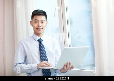 Portrait of young bisiness man with laptop high quality photo Stock Photo