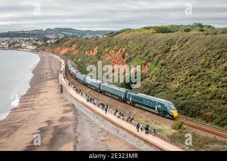 An unidentified First Great Western Class 800 skirts the sea wall at Dawlish, Devon Stock Photo