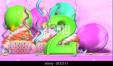 Birthday cupcake with sparking candle with the number 2 large in green with cupcakes with red cream decorated with chocolate chips and balloons on the Stock Photo