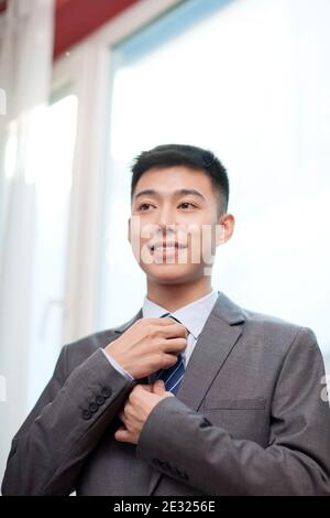 Portrait of a young bisiness man tying high quality photo Stock Photo
