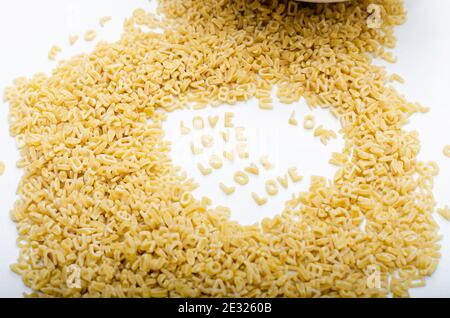 Alphabet soup on white background word love Stock Photo