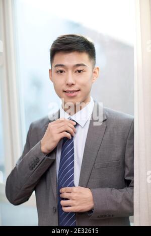 Portrait of a young bisiness man tying high quality photo Stock Photo