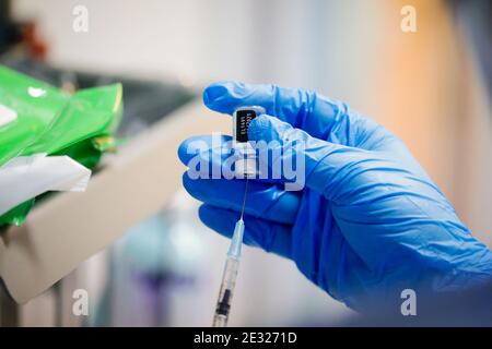 Bucharest, Romania - January 15, 2021: Details with the hands of a medical worker preparing a dose of the Pfizer BioNTech anti COvid 19 vaccine. Stock Photo