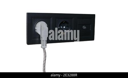 Electrical outlet isolated on white background, black outlet with plug, triple outlet with grounding and antenna adapter. Stock Photo