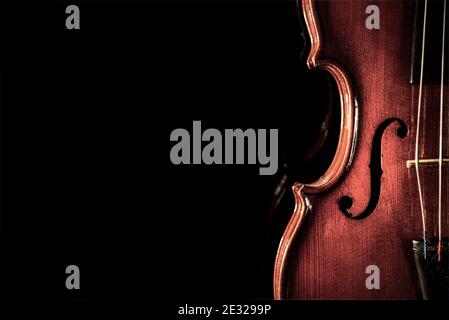 An antique violin on a black background, detail, close up Stock Photo