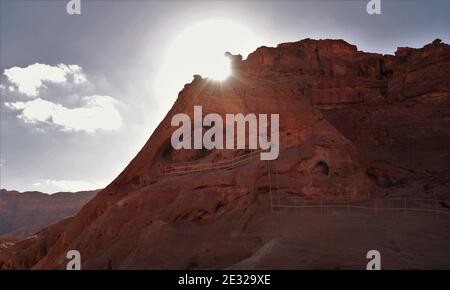 Stunning shot of an eroded rock arch with the sun setting behind Stock Photo