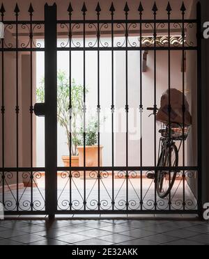 Bike behind a closed gate after shopping. Stock Photo