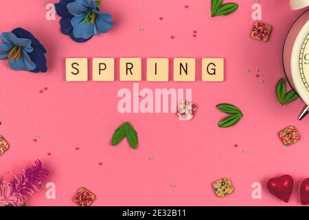 Spring decorative background, flat lay concept on a vibrant pink with decorative flowers and accessories photo Stock Photo