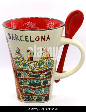 Photo of Gaudi designs on a souvenir ceramic mug with a spoon on a white background from Barcelona Catalunya Spain Stock Photo