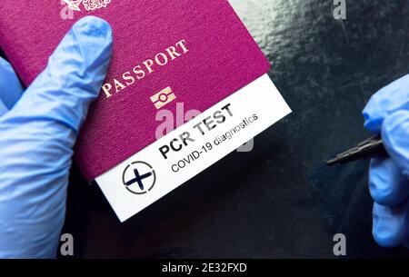 COVID-19 and travel concept, mark of positive coronavirus PCR testing in tourist passport. PCR test in airport due to border restrictions during pande Stock Photo