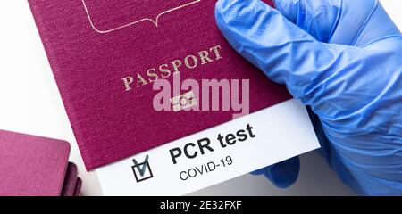 COVID-19 and travel concept, mark of coronavirus PCR testing in tourist passport. Diagnostics of coronavirus in airport due to lockdown. Business and Stock Photo