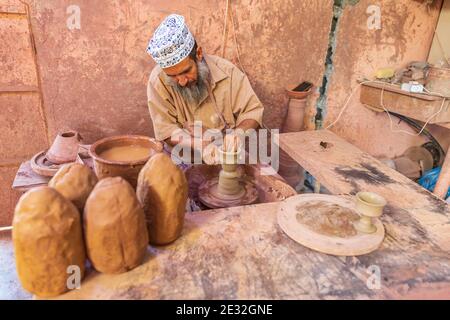 Middle East, Arabian Peninsula, Oman, Ad Dakhiliyah, Bahla. Oct. 23, 2019. Man working at a potter's wheel at the Aladawi pottery factory in Oman. Stock Photo