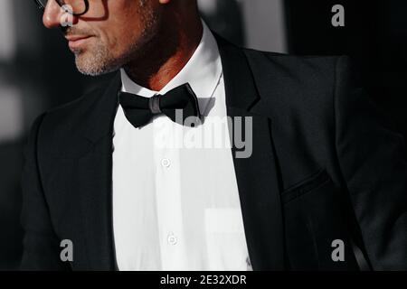 Cropped view of elegant man in black and bow tie. Concept of men stylish elegance clothes with place for your text Stock Photo