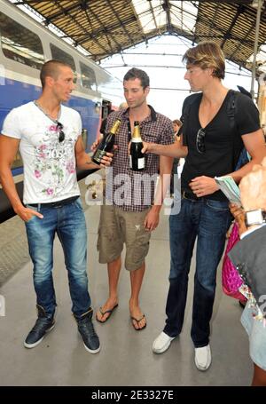 French swimmers and European medalists Frederick Bousquet (L), William Meynard (C) and Camille Lacourt (R) drink champagne at Marseille Saint-Charles train station in Marseille, France on August 17, 2010 as they arrive from the European swimming championships in Budapest. France won 23 medals including 8 gold, 8 silver and 7 bronze and ranked first, in front of Russia and Germany. Photo by Jeremy Charriau/ABACAPRESS.COM Stock Photo