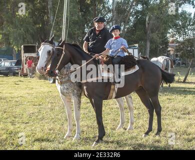 Man and boy gauchos on horseback Argentina Stock Photo