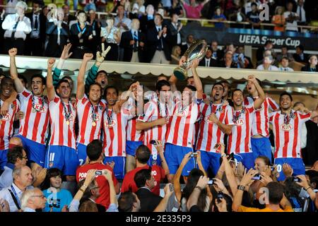 Athletico Madrid's players celebrate with the cup after winning the match against Inter Milan after the UEFA Supercup soccer match, Inter Milan vs Athletico Madrid at Louis II of Monaco Stadium in Principaute of Monaco on August 27, 2010. Athletico Madrid won 2-0. Photo by Henri Szwarc/ABACAPRESS.COM Stock Photo