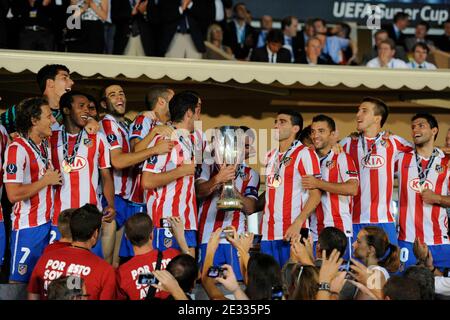 Athletico Madrid's players celebrate with the cup after winning the match against Inter Milan after the UEFA Supercup soccer match, Inter Milan vs Athletico Madrid at Louis II of Monaco Stadium in Principaute of Monaco on August 27, 2010. Athletico Madrid won 2-0. Photo by Henri Szwarc/ABACAPRESS.COM Stock Photo