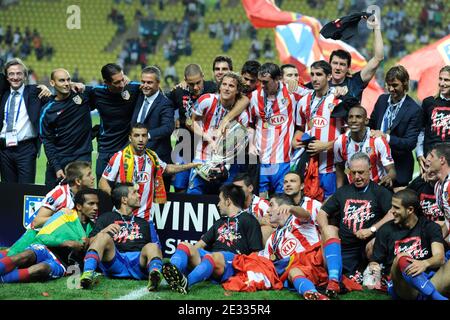 Athletico Madrid's players celebrate with the cup after winning the match against Inter Milan after the UEFA Supercup soccer match, Inter Milan vs Athletico Madrid at Louis II of Monaco Stadium in Principaute of Monaco on August 27, 2010. Athletico Madrid won 2-0. Photo by Henri Szwarc/ABACAPRESS.COM Stock Photo