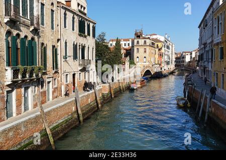 People walk on the Fondamenta Briati next to rio del Carmini canal in the sestiere of Dorsoduro, Venice, Italy Stock Photo