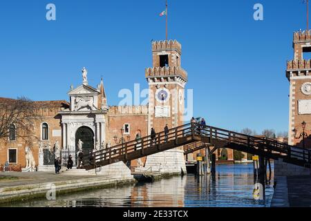 The main gate at the Venetian Arsenal with Ponte de L'Arsenal o del Paradiso wooden bridge in Venice, Italy Stock Photo