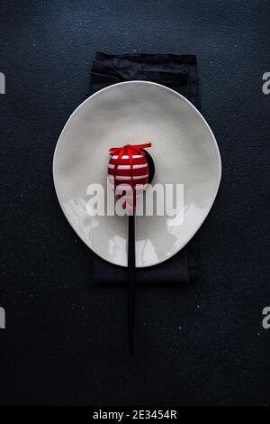Minimalistic Easter table setting on black concrete background Stock Photo