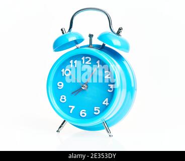 Hand of hispanic man holding blue alarm clock over isolated white background. Stock Photo