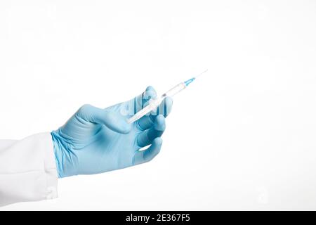 Hand in blue glove holding syringe isolated on white background. Stock Photo