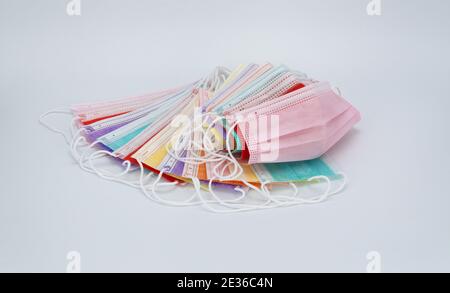 colored medical masks on a white background. sterile bandages on the face to protect against viruses and infections.  Stock Photo